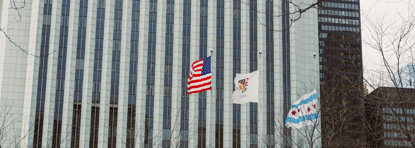 Downtown Chicago commercial building flying the United States, Illinois and Chicago flags