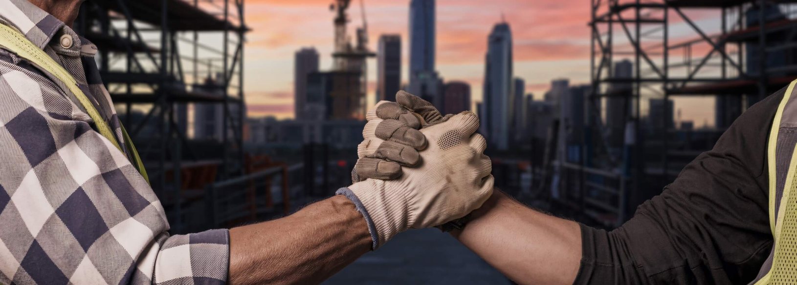 Construction workers with a city skyline behind them