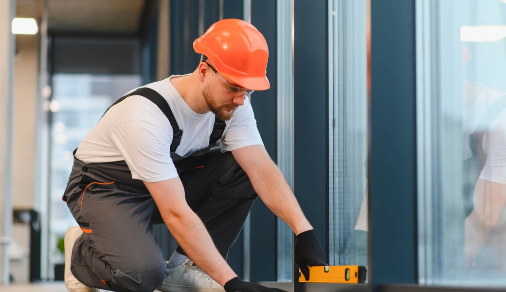Worker using a spirit level to check a floor during installation